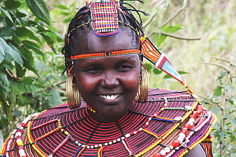 Portrait of smiling African woman in traditional Maasai beadwork