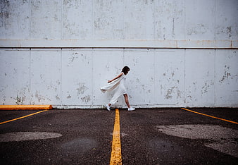 Woman in White Dress Walking in Parking Lot