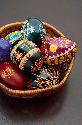Colorful Hand-Painted Easter Eggs in Wicker Basket