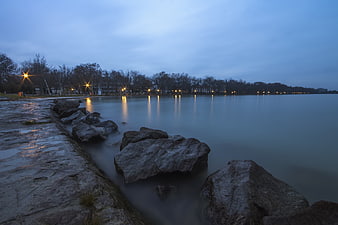 Long Exposure Coastal Rocks at Blue Hour with City Lights