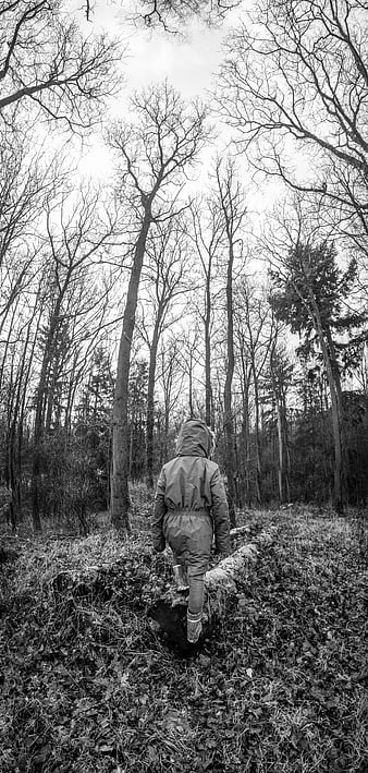 Child in Raincoat Walking Through Winter Forest