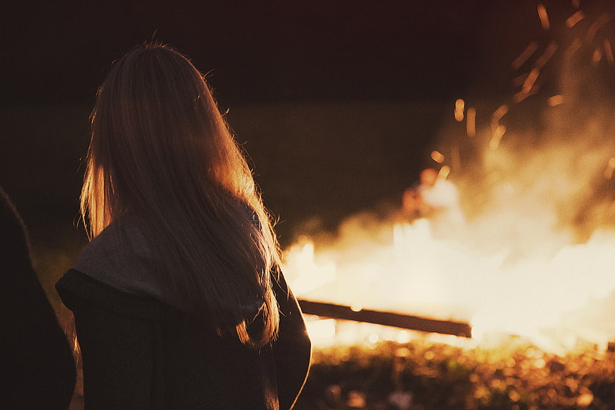Woman Watching Bonfire at Night
