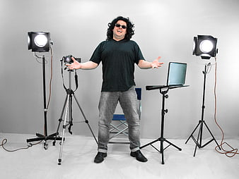 Man with Camera and Lights in Photo Studio