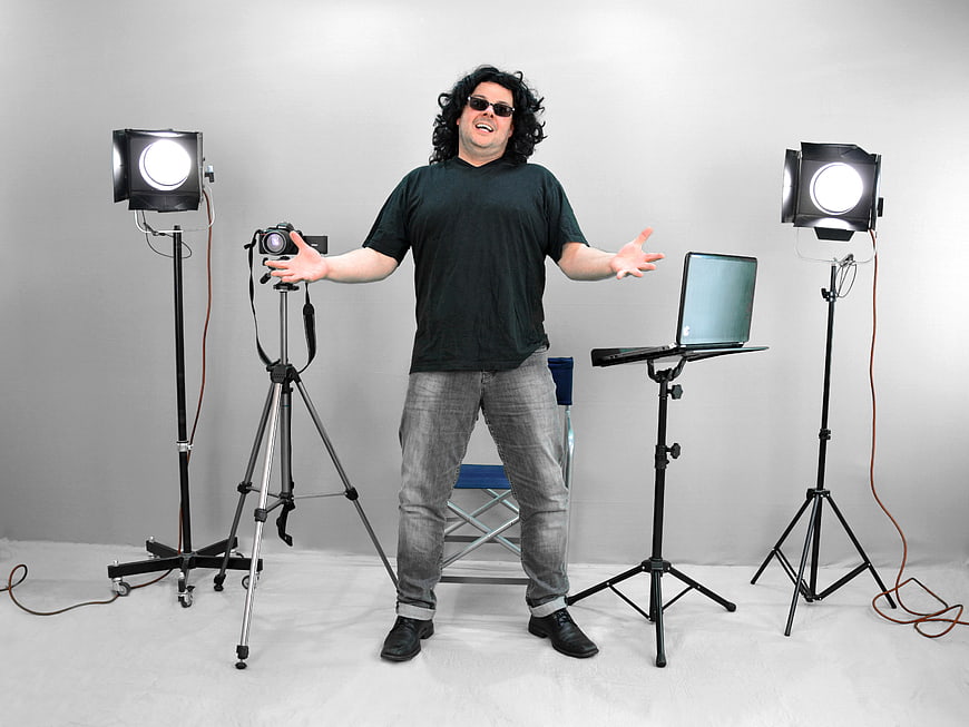 Man with Camera and Lights in Photo Studio