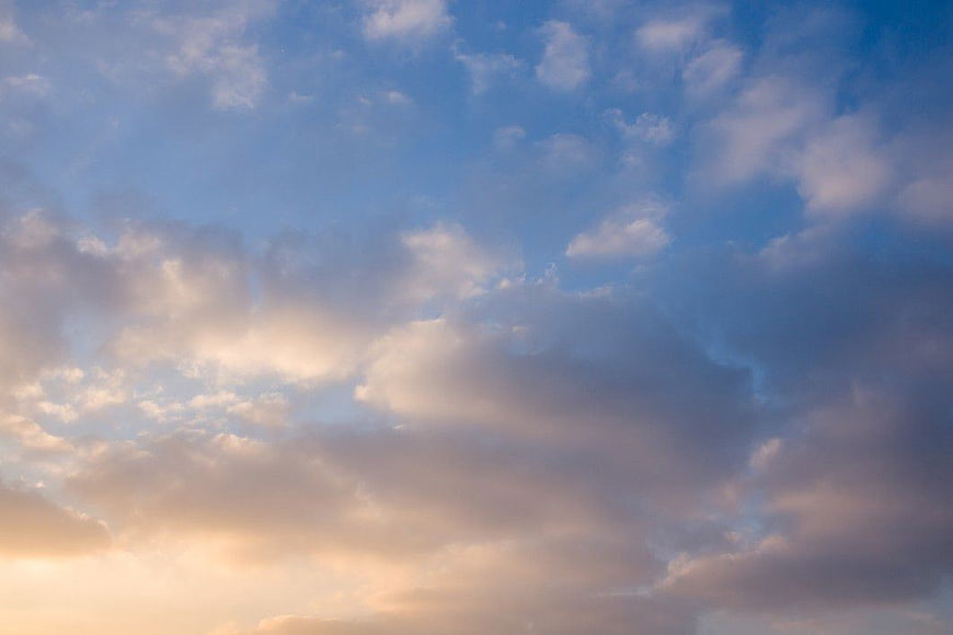 Dramatic Clouds in Blue Sky with Golden Sunset Light
