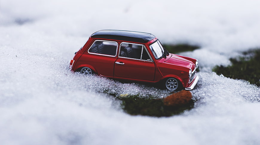 Red Mini Cooper Toy Car in Snowy Winter Landscape