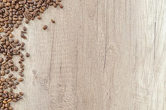 Roasted coffee beans on rustic wooden background with copyspace