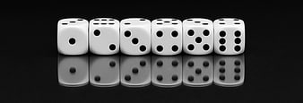 Row of white dice on black background with reflection