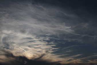Dramatic dark clouds with sunlight breaking through at sunset