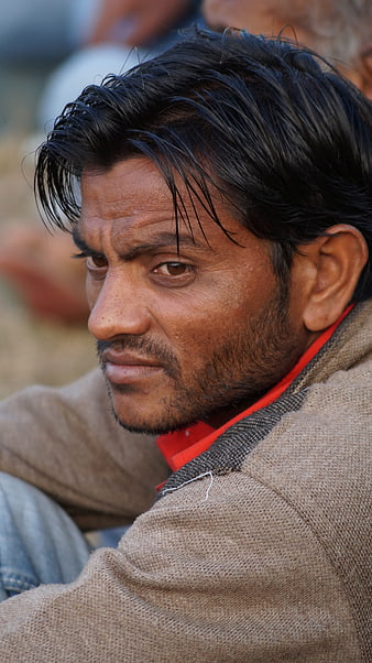 Close-up portrait of a man with intense gaze and textured skin