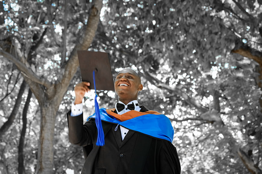Happy African American Graduate Throwing Cap in Joyful Celebration