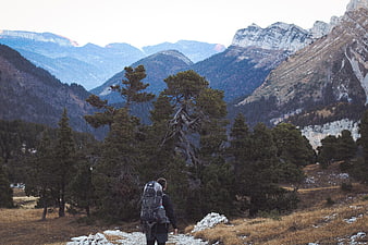 Hiker with Backpack Looking at Mountain Landscape
