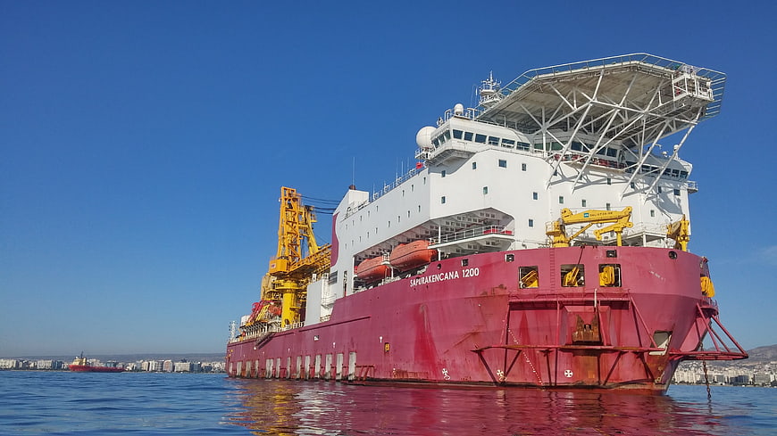 Large Red Cargo Ship Docked in Harbor