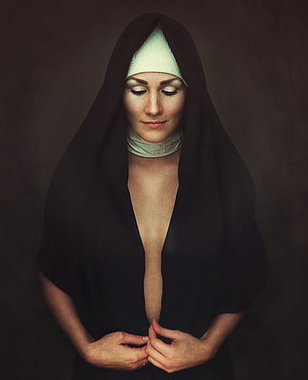 Sensual portrait of a woman in a nun habit with eyes closed