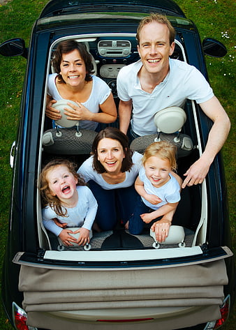 Happy family group portrait inside convertible car