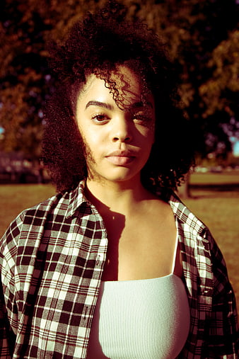 Portrait of Young Woman with Curly Hair in Plaid Shirt