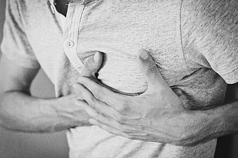 Man clutching chest in pain black and white photo