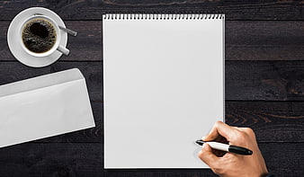 Top View of Hand Writing on Notepad with Coffee and Envelope