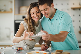 Happy couple cooking breakfast together in modern kitchen