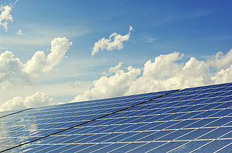 Blue Solar Panels Against a Cloudy Sky