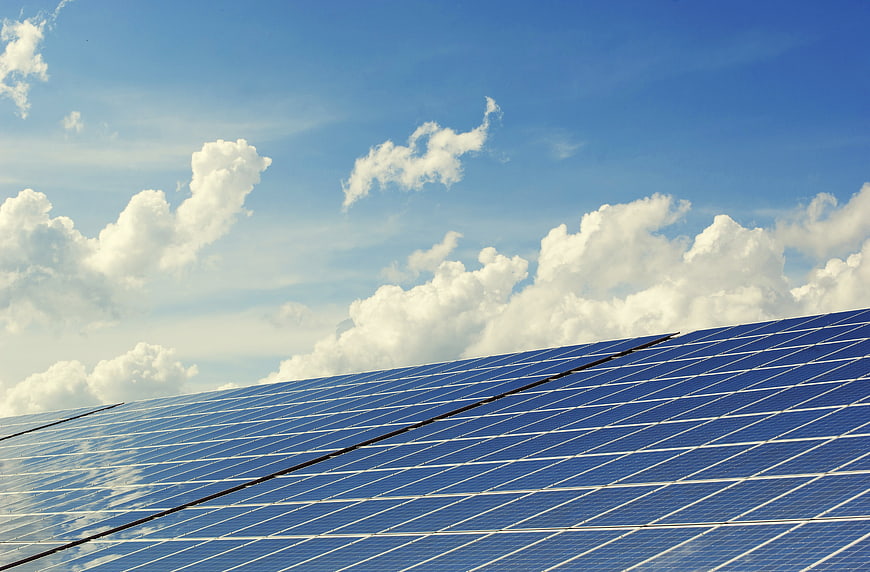 Blue Solar Panels Against a Cloudy Sky