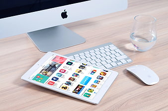 White Tablet on Wooden Desk with Apple Computer Setup