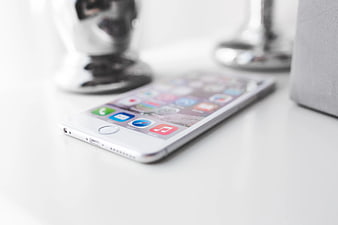 White iPhone 6 Plus on a minimalist white desk