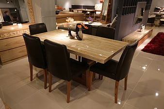 Modern Dining Table Set With Black Leather Chairs In Furniture Showroom