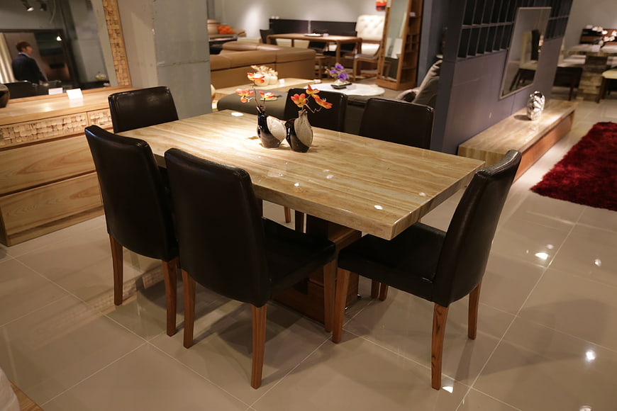 Modern Dining Table Set With Black Leather Chairs In Furniture Showroom