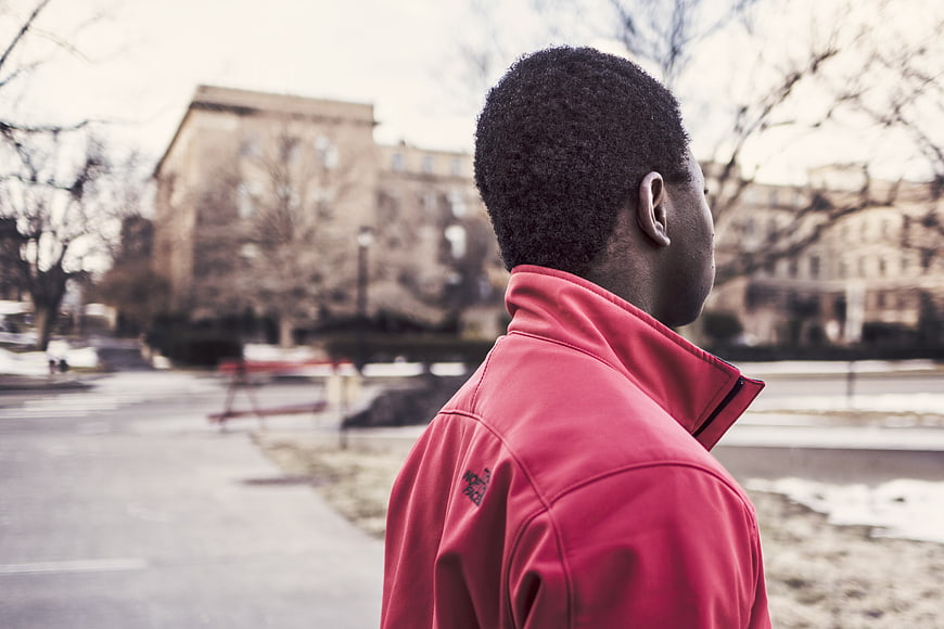 Man in Red Jacket Looking Away in Winter Park