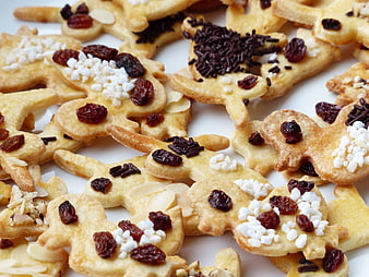 Close-up of gingerbread man cookies with raisins and sprinkles