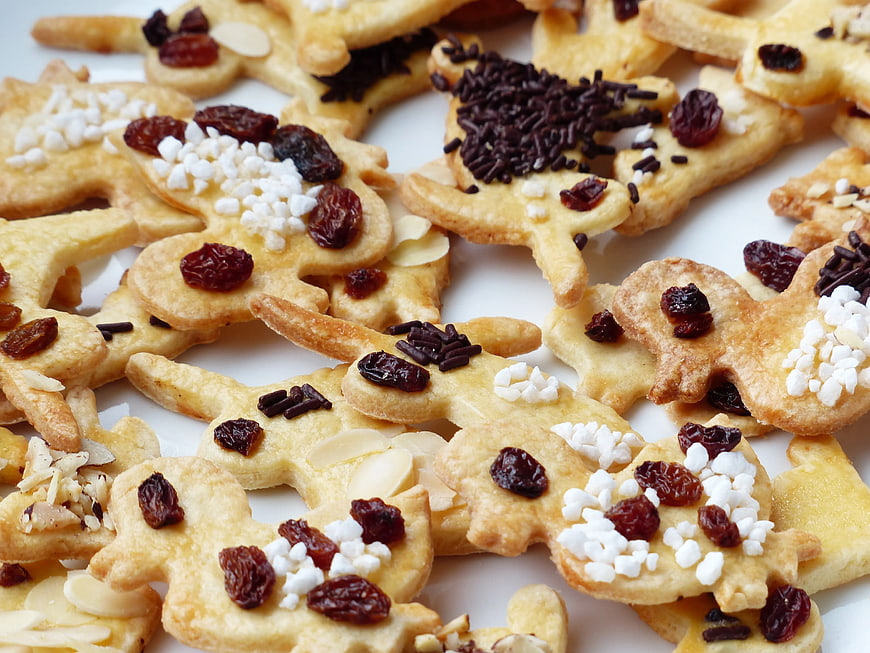 Close-up of gingerbread man cookies with raisins and sprinkles