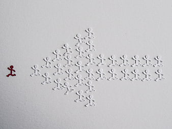 Red figure leading white group in arrow formation on white background