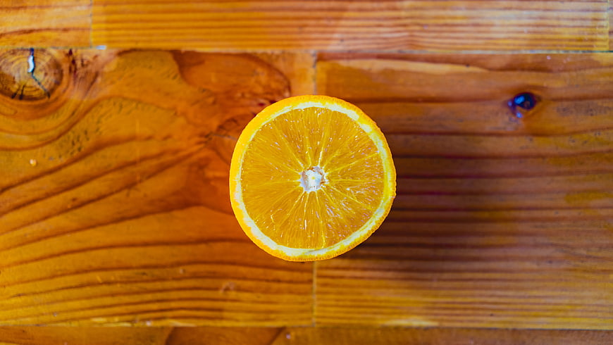 Fresh Sliced Orange on Rustic Wooden Table Top View