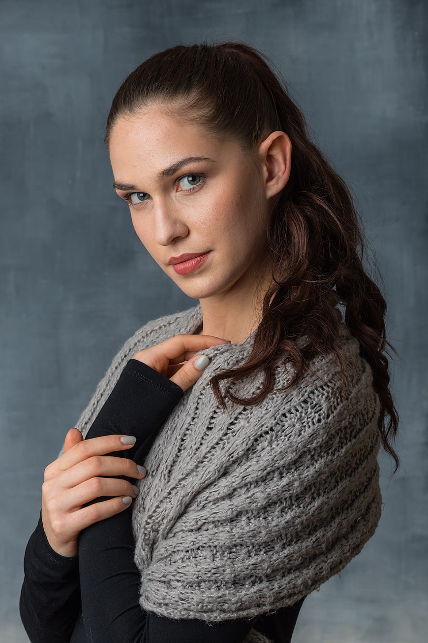 Studio Portrait of Young Woman Wearing Knitted Shawl