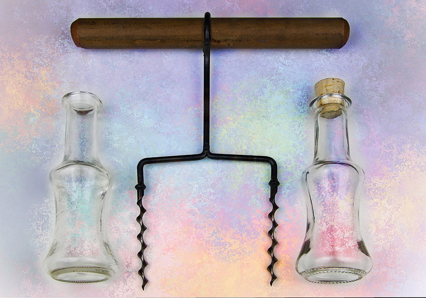 Vintage Corkscrew and Glass Bottles on Iridescent Background