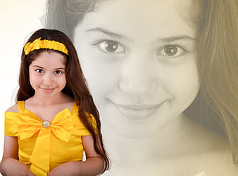 Young girl in yellow dress with large background portrait