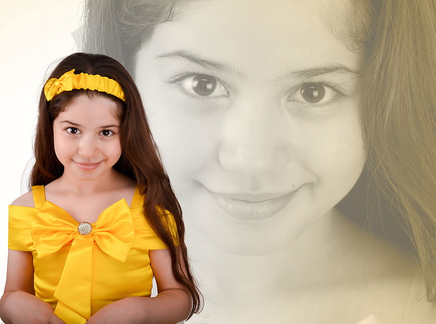 Young girl in yellow dress with large background portrait