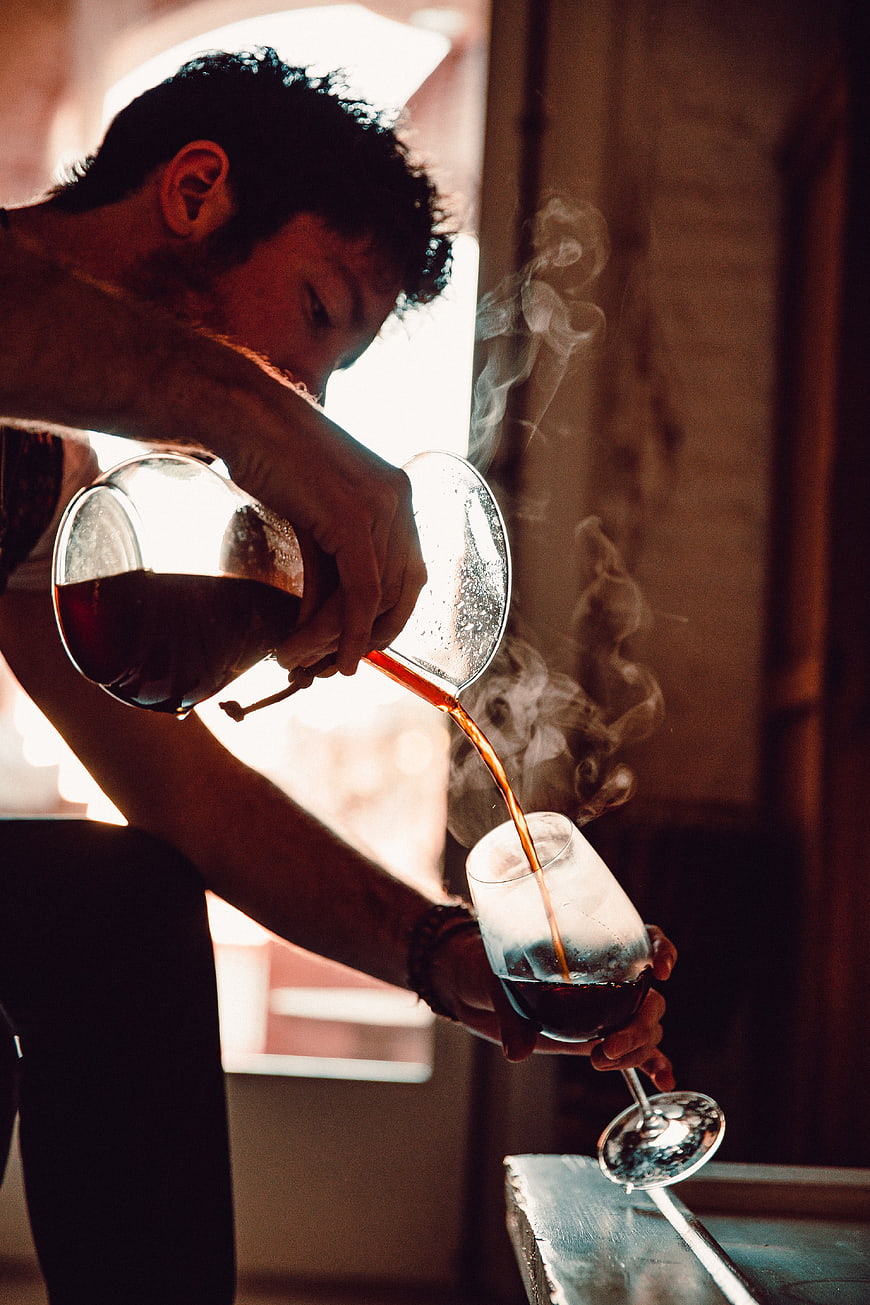 Barista Pouring Hot Coffee into Glass