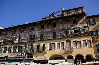 Historic frescoed building in Verona, Italy with blue sky