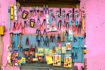 Colorful Hand Tools Displayed On Pink Wall