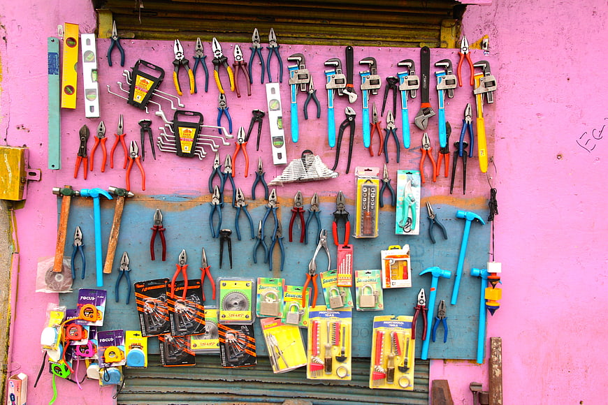 Colorful Hand Tools Displayed On Pink Wall