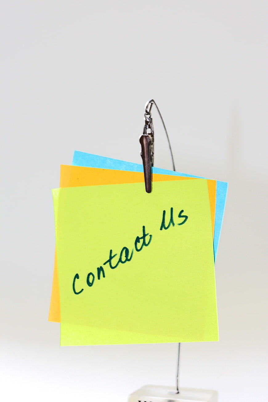 Colorful Sticky Notes With Contact Us Text Hanging On Wire