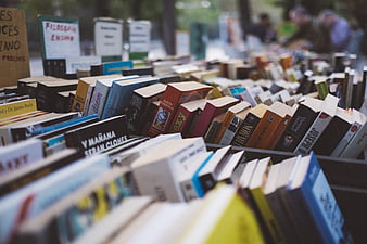 Rows of used books at an outdoor market stall