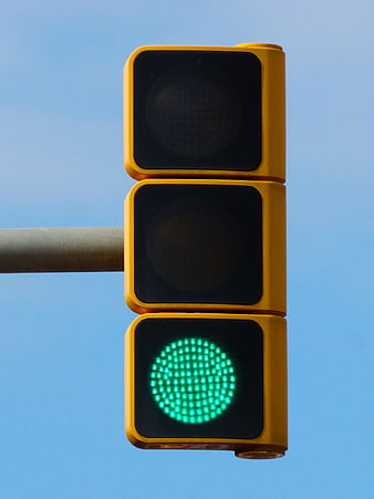 Green Traffic Light Signal Against Clear Blue Sky