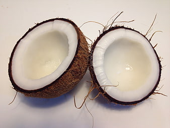 Halved Coconut With White Flesh And Water On White Background