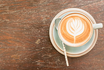 Top View of Cappuccino with Latte Art on Rustic Wood