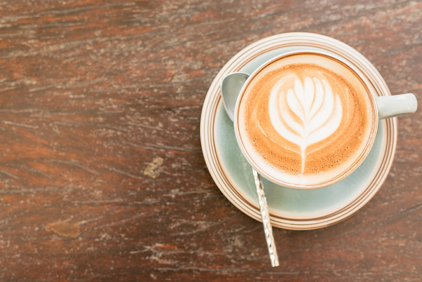 Top View of Cappuccino with Latte Art on Rustic Wood