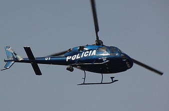 Blue Police Helicopter In Flight Against Clear Sky
