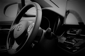Black and white Toyota steering wheel and dashboard interior
